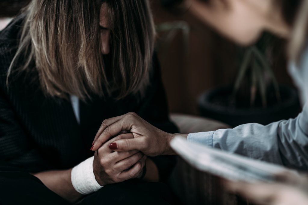 Psychotherapist Talking with Woman Suffering from PTSD.